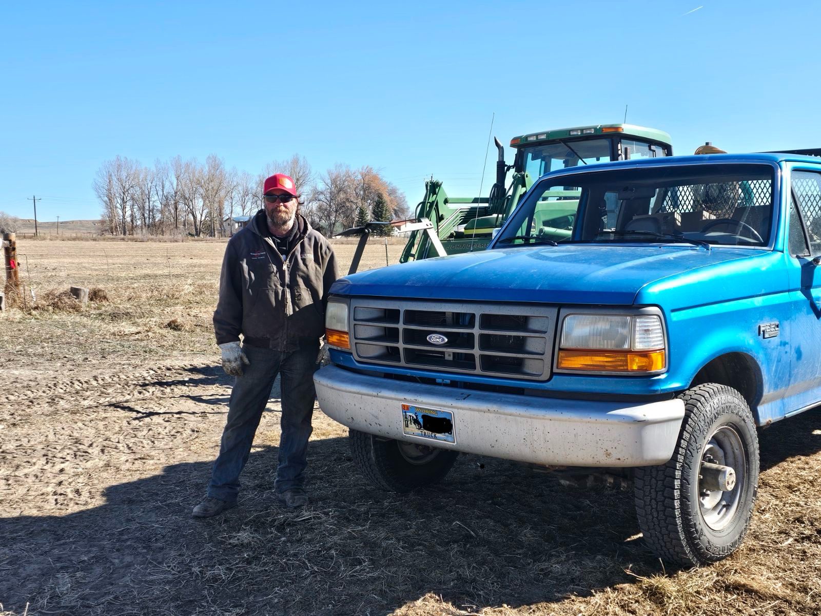 Brent standing beside a blue truck