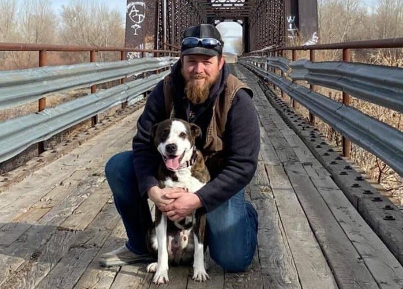 jeff with his dog on a bridge